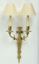 A SET OF THREE BRASS TWO-BRANCH WALL SCONCES,<br> IN LOUIS XVI STYLE<br><br>