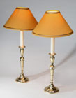 A PAIR OF GEORGE III BRASS TABLE CANDLESTICKS, FITTED FOR ELECTRIC LIGHT