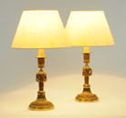 A SUBSTANTIAL PAIR OF GILT-BRONZE CANDLESTICKS, IN LOUIS XVI STYLE, ADAPTED AS TABLE LAMPS